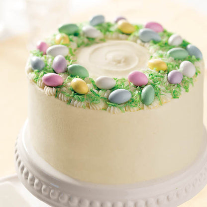 Festive Vanilla Buttercream Cake with coconut "grass" and sugared Jordan almonds